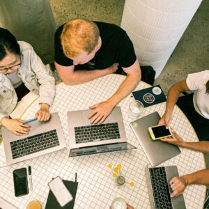 Top view of diverse team collaboratively working in a modern office setting.